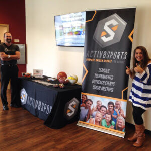 Activ8 sports banner displayed above a table throw, promoting athletic events and activities in a vibrant design.