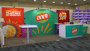 A 10x20 rental booth for Ayo Foods at Natural Products Expo West 2024, highlighting their natural food products and branding.
