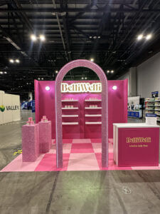 BelliWelli custom rental booth with pink glitter and a pink checkered floor at Walmart YBM 2025.