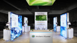 Custom 20x20 rental booth for Wolters Kluwer featuring a vibrant living plant wall as a focal point.