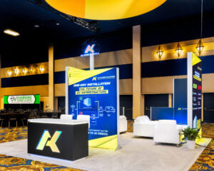 AK Power Solutions' rental booth showcases light boxes, holograms, and a uniquely designed counter for engagement.