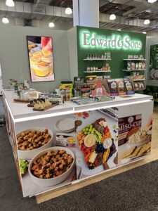 Edward and Sons showcase their custom rental booth at Summer Fancy Food, offering product sampling in an engaging environment.