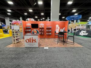 A 10x20 custom booth for OTIS, featuring product and a striking backlit 3D logo for enhanced visibility and appeal.