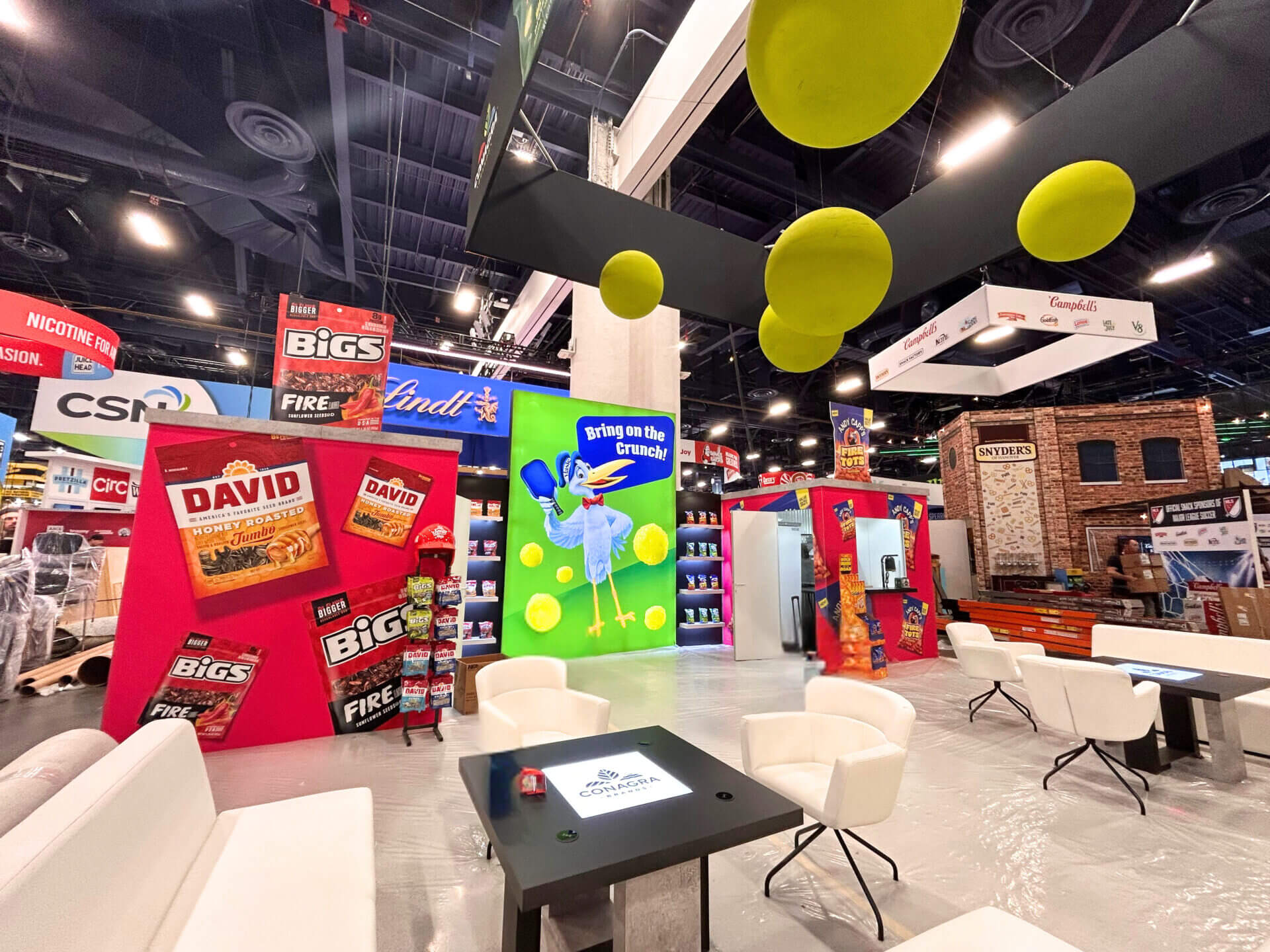 Picture of Conagra booth with pickle balls hanging from the hanging banner