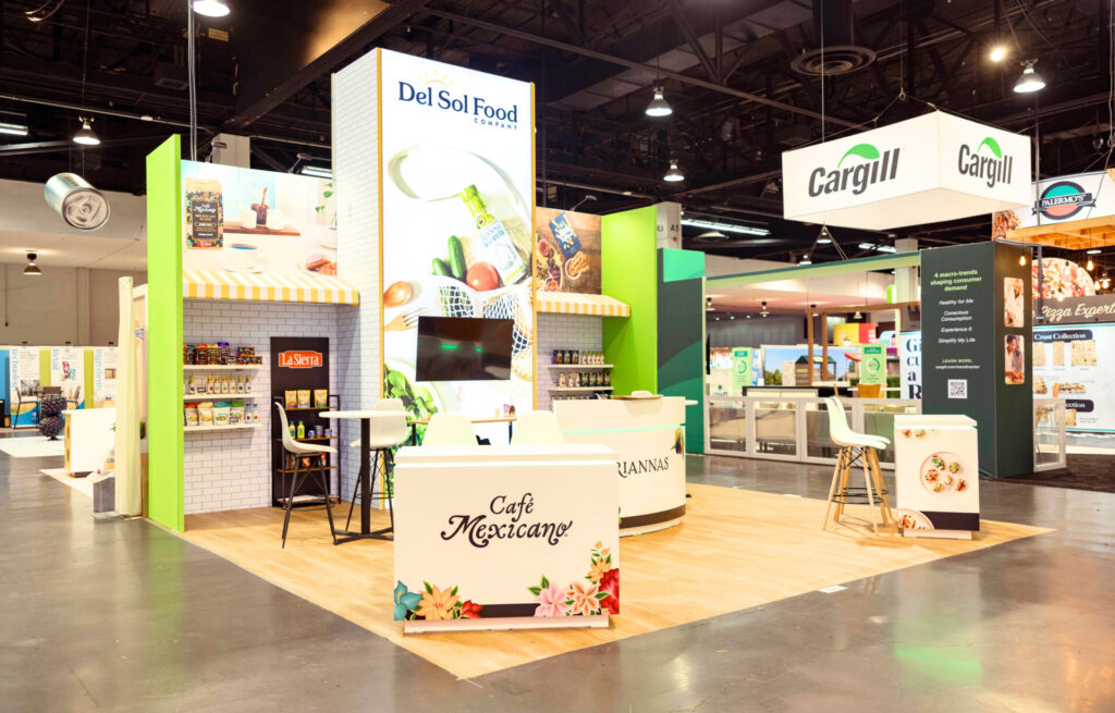 Del Sol Food Company trade show booth rental at Expo West with branded counters, backlit tower and product displays