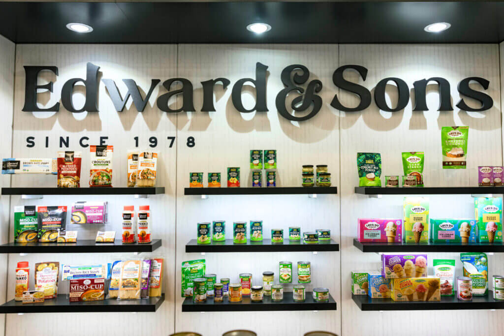 Custom trade show booth for Edward & Sons with product displays and seating area