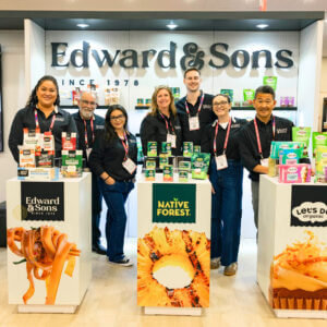 Custom trade show booth for Edward & Sons with product displays and seating area